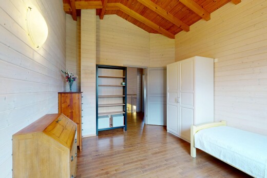 room with light wood-style flooring, wood walls, and a high wood beamed ceiling