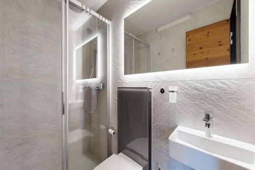 full bath with a stall shower and tile walls
