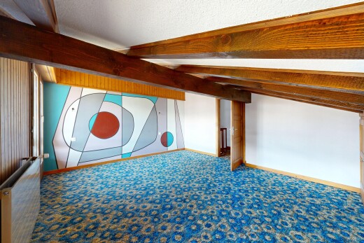 empty room with beamed ceiling, carpet floors, and a textured ceiling