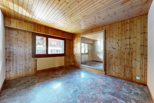 spare room featuring healthy amount of natural light, wood walls, wooden ceiling, and radiator