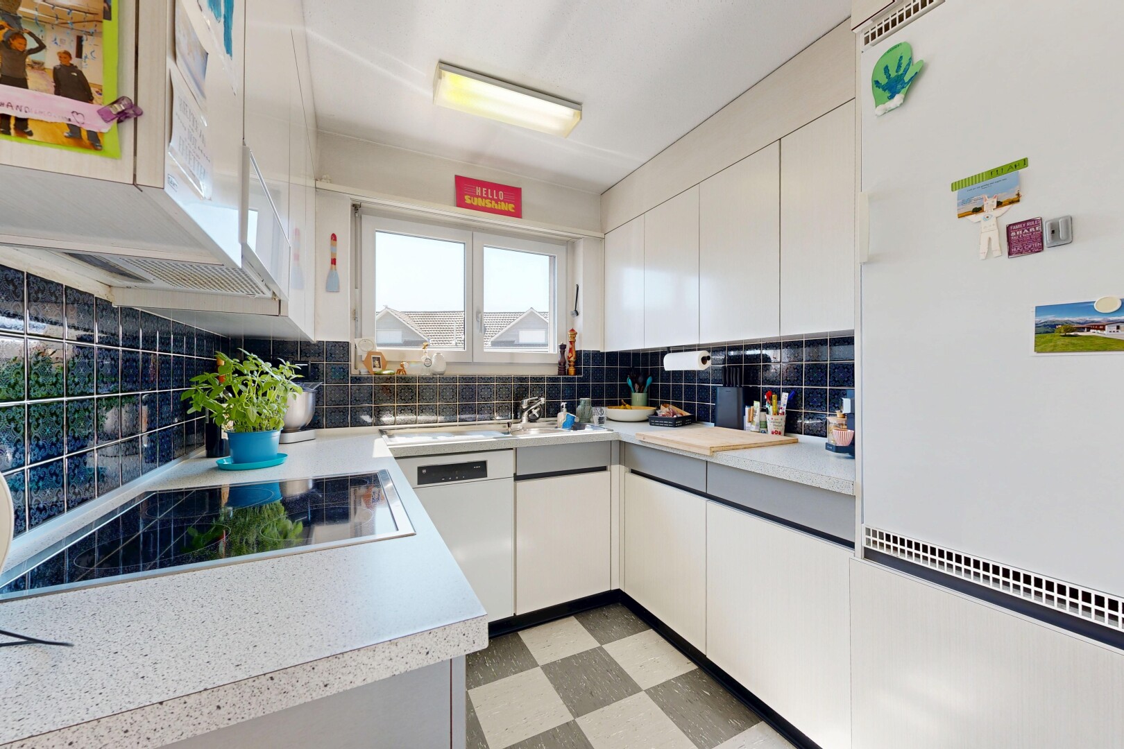 kitchen with white appliances, light countertops, and white cabinetry