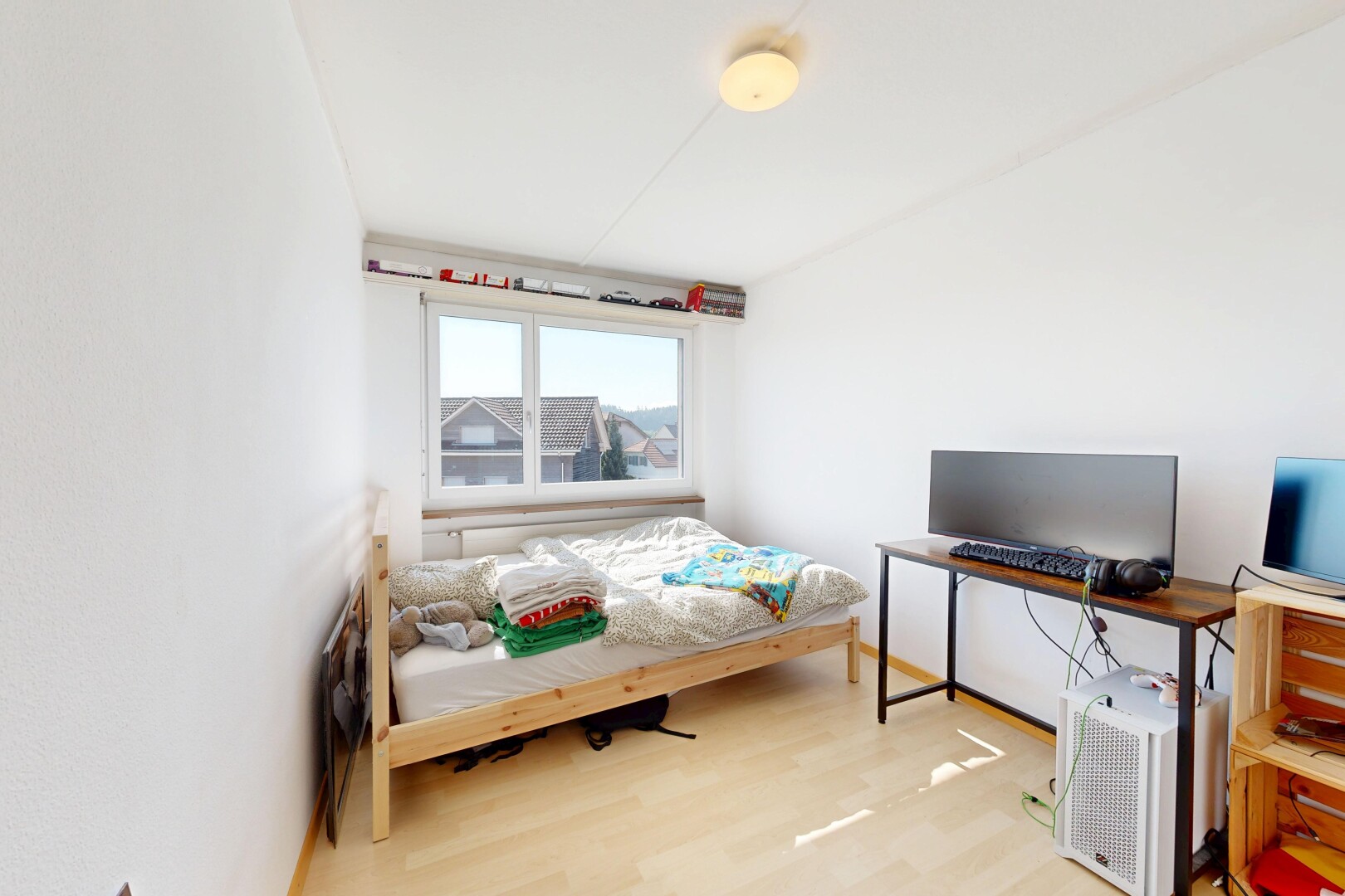 room / bedroom with light wood-type flooring and a desk