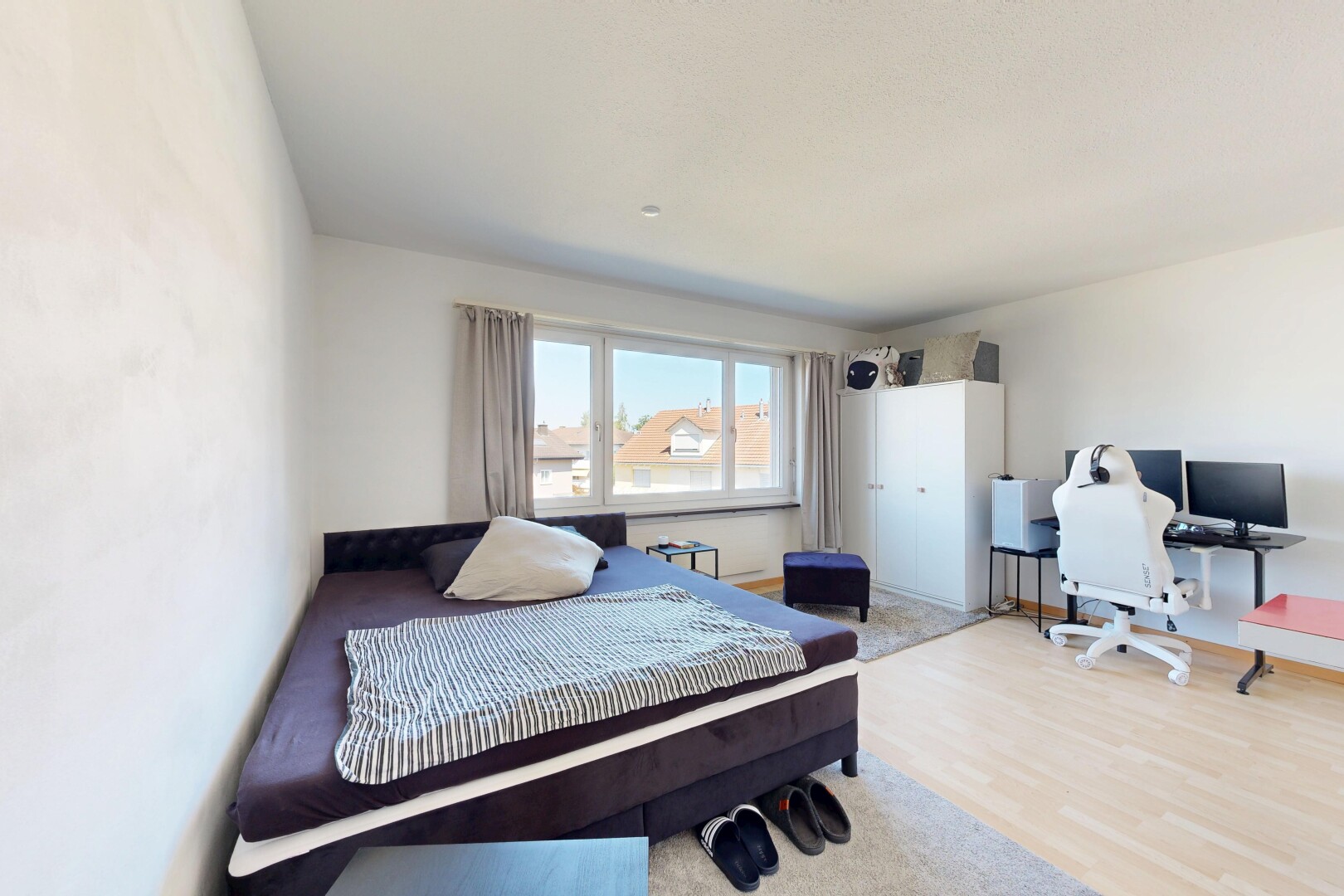 room / bedroom featuring an office area and light wood-style floors