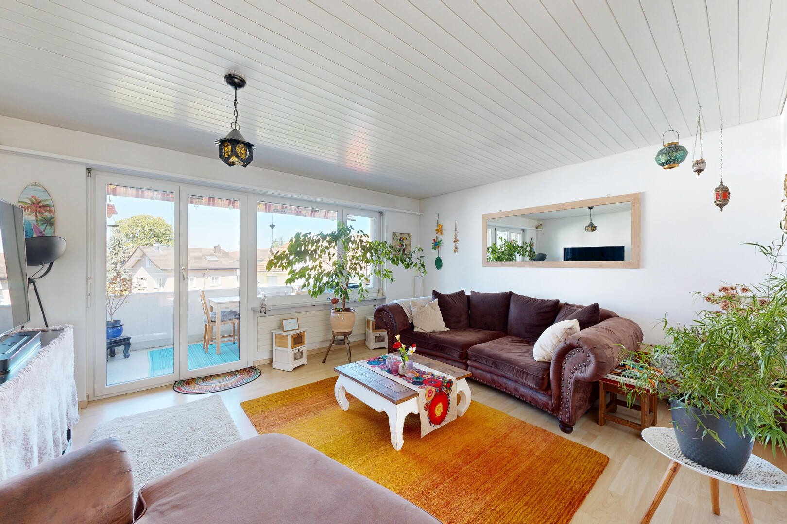 living area with decorative light fixtures and wood ceiling