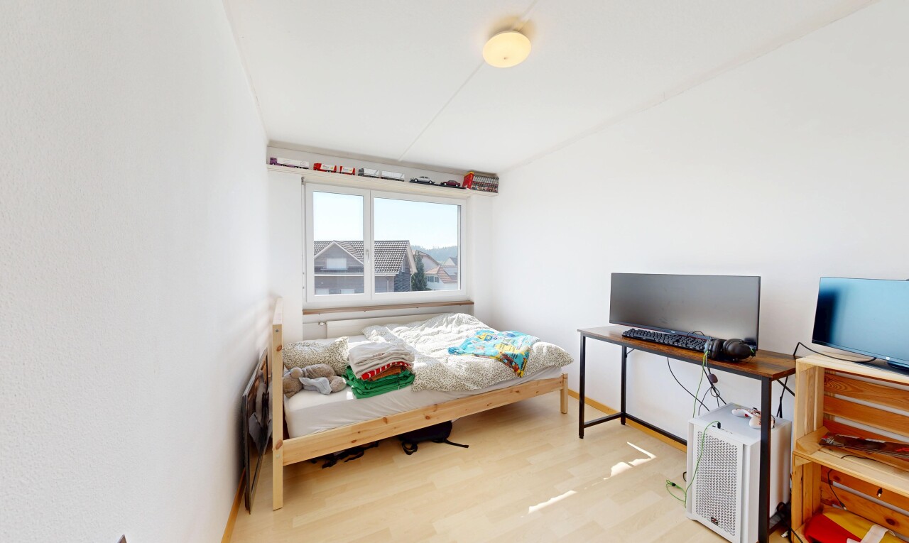 room / bedroom with light wood-type flooring and a desk