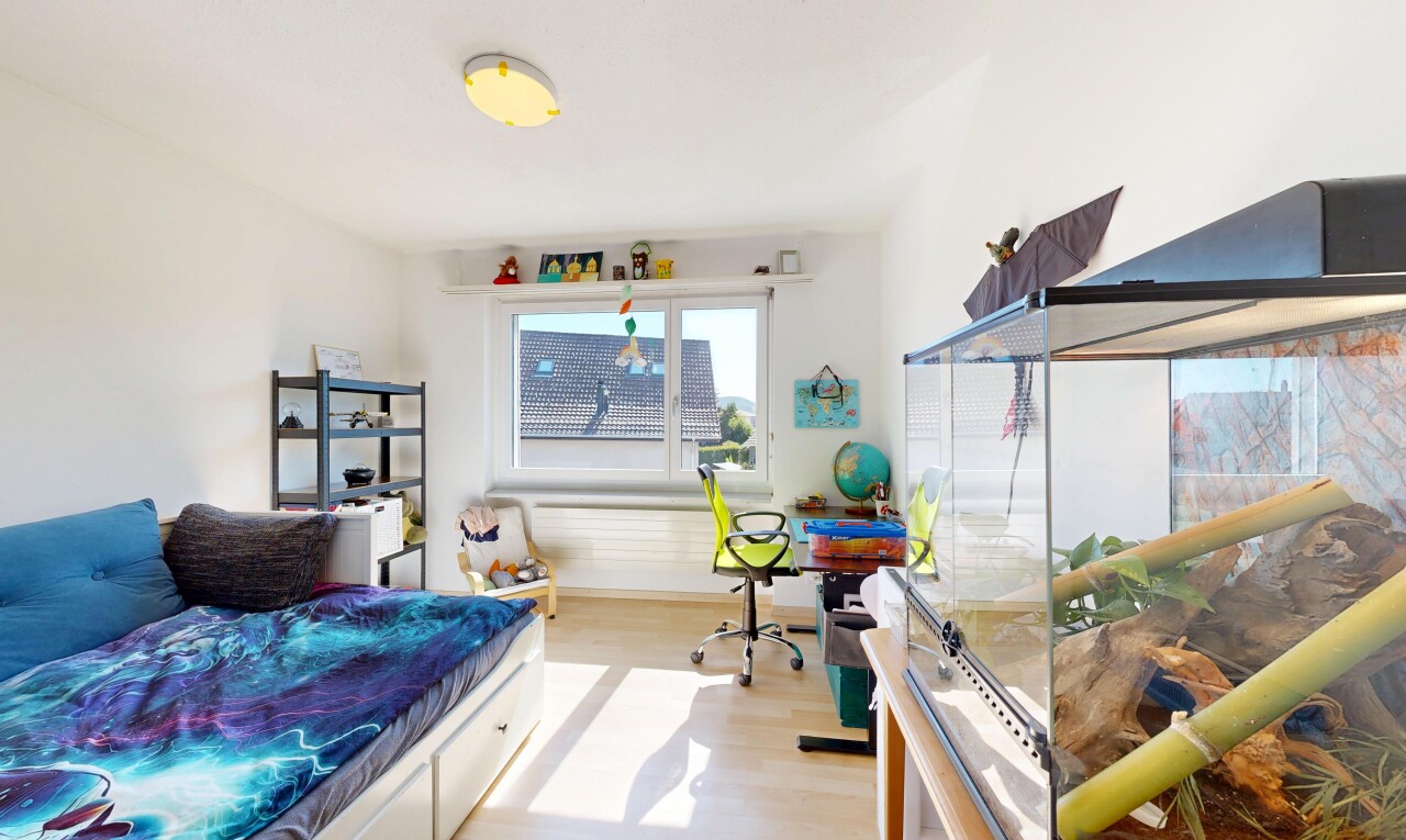 room / bedroom with light wood-style floors and a desk