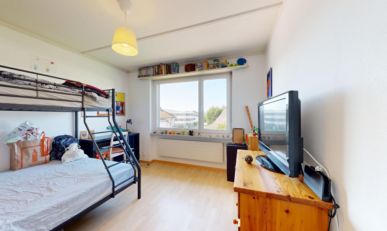 room with decorative light fixtures and light wood-style flooring