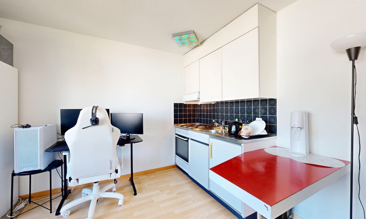 kitchen with tasteful backsplash, light wood-style floors, white cabinetry, dark countertops, and stainless steel oven