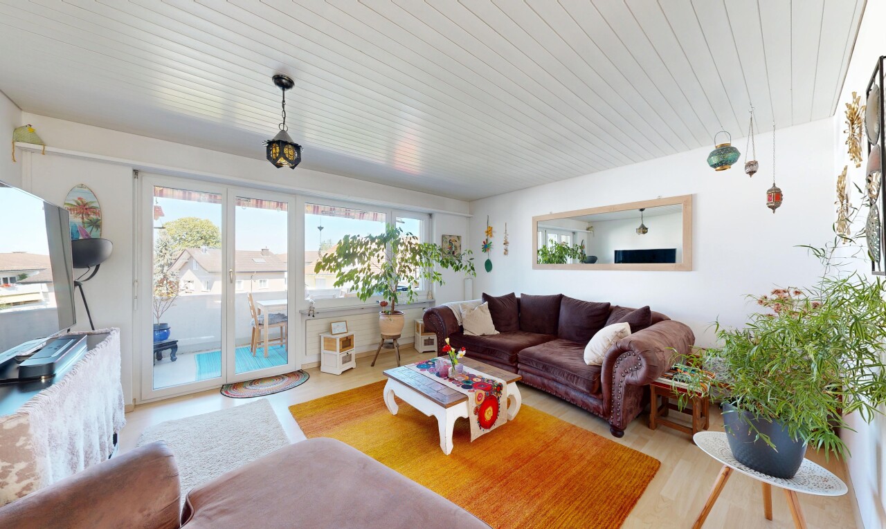 living area with decorative light fixtures and wood ceiling