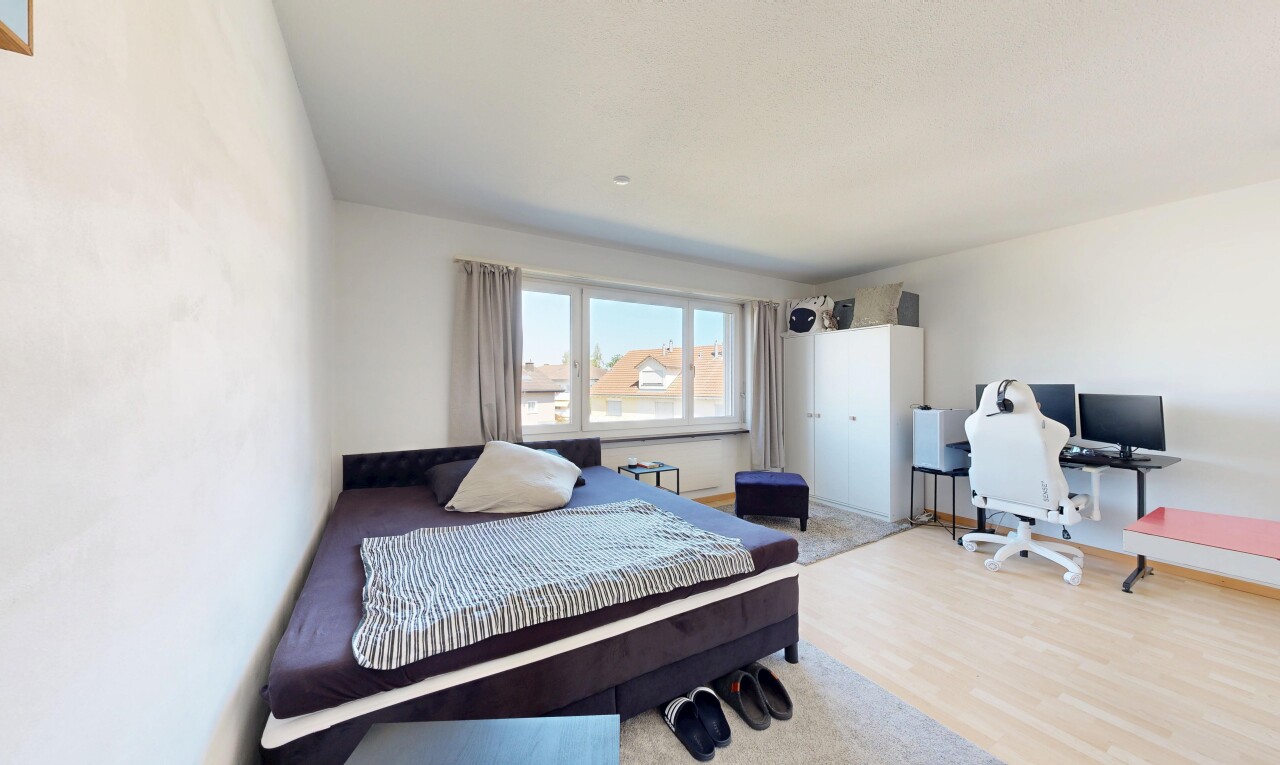 room / bedroom featuring an office area and light wood-style floors