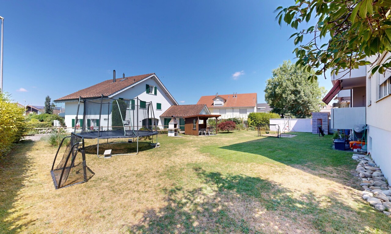 outdoor house with a fenced backyard and a trampoline
