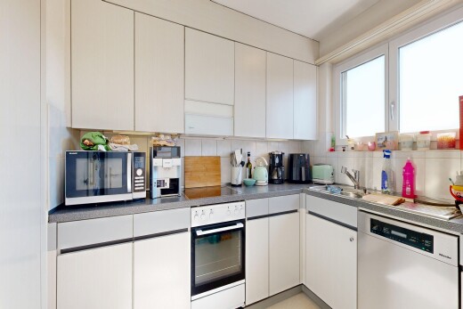 kitchen featuring stainless steel dishwasher, white oven, tasteful backsplash, white cabinetry, and dark countertops
