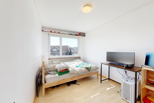room / bedroom with light wood-type flooring and a desk
