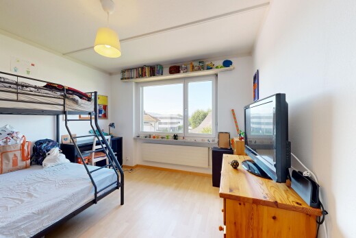 room with decorative light fixtures and light wood-style flooring