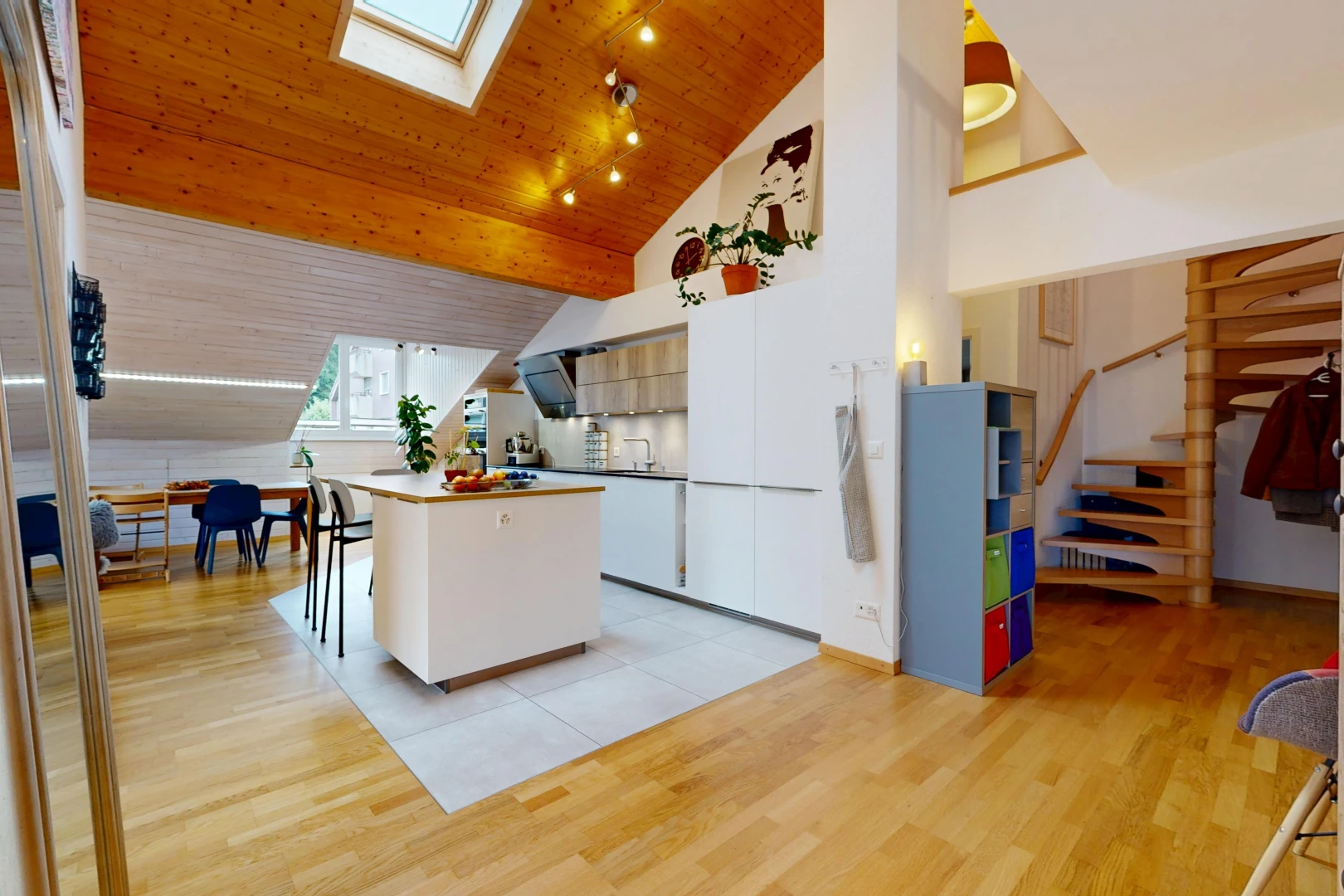kitchen with vaulted ceiling with skylight, a kitchen island, light wood-style floors, rail lighting, and wooden ceiling