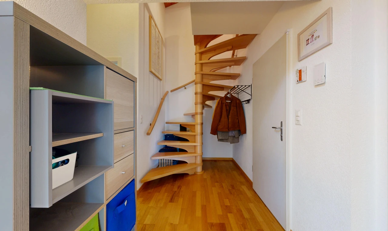 stairs with light wood finished floors