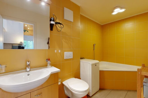 full bath with vanity, tile walls, a bath, and light tile patterned flooring