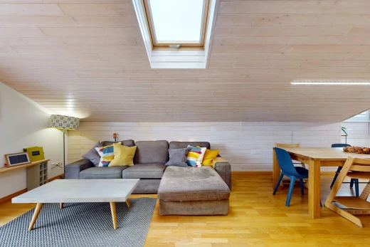 living area with lofted ceiling with skylight, wooden ceiling, wood walls, and light wood-style flooring