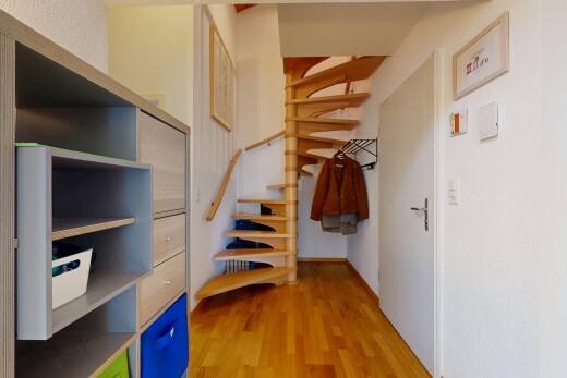 stairs with light wood finished floors