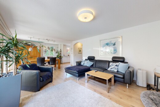 living area featuring arched walkways and light wood-type flooring