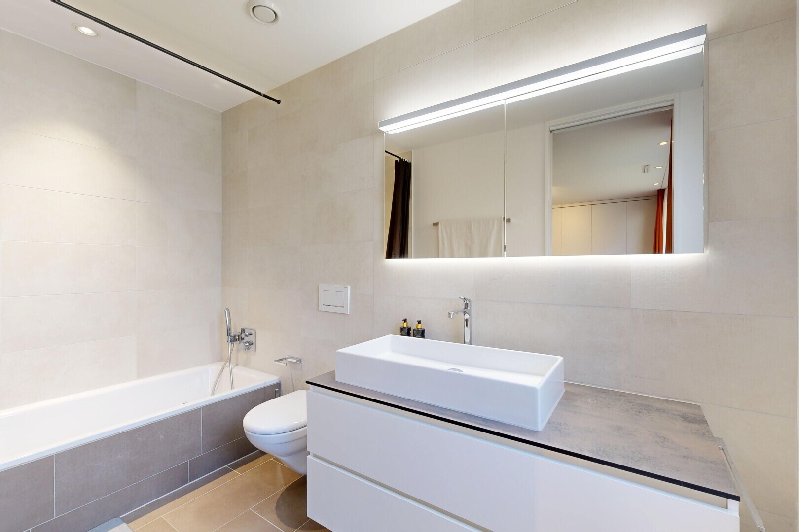 full bath with tiled shower / bath combo, vanity, tile walls, and light tile patterned flooring