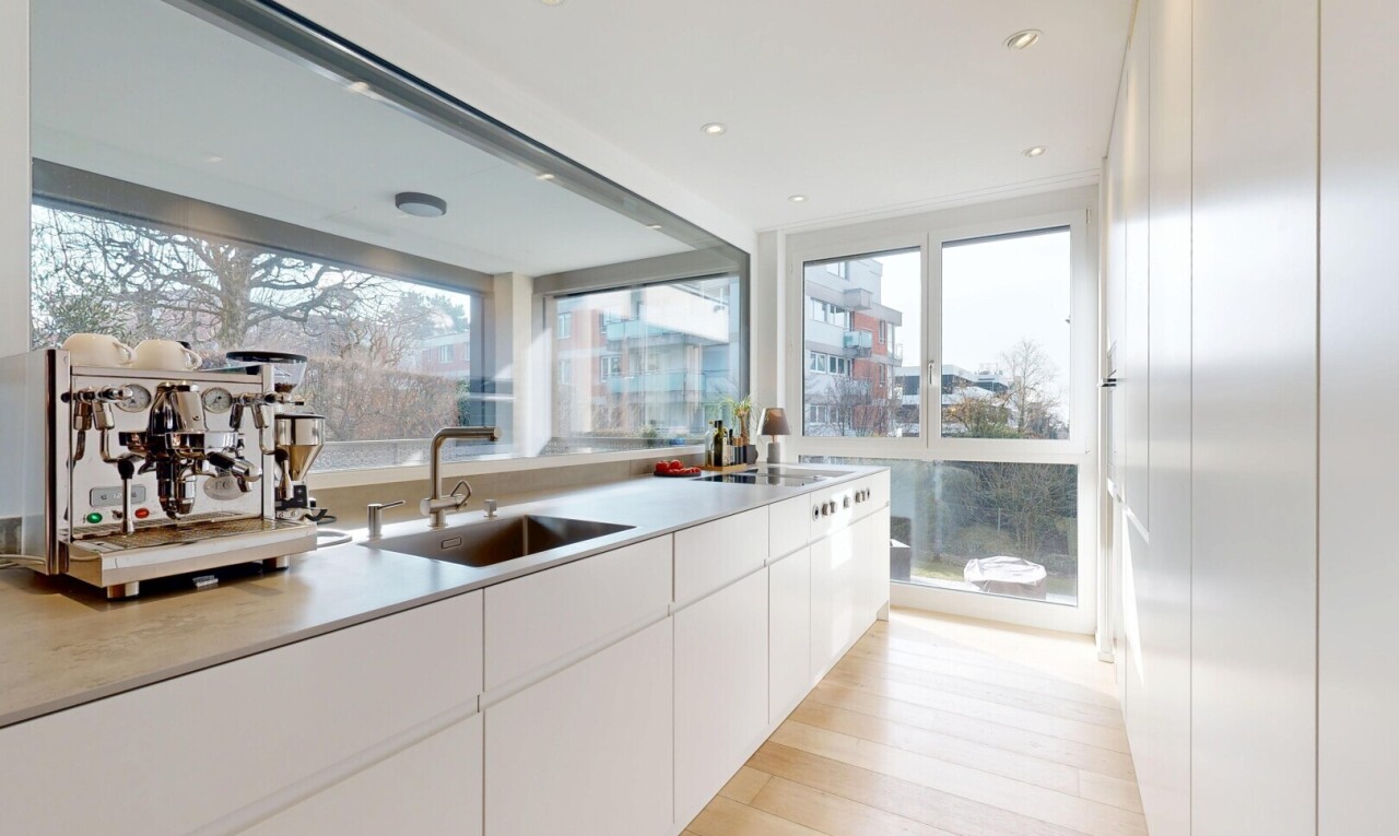kitchen with light countertops, white cabinetry, light wood-type flooring, and modern cabinets