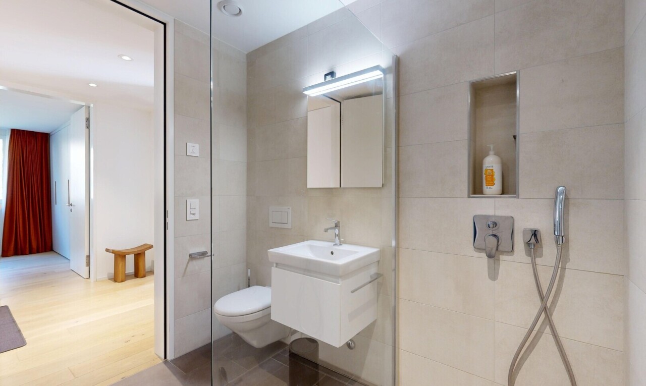 bathroom featuring tile walls, vanity, a walk in shower, and wood finished floors