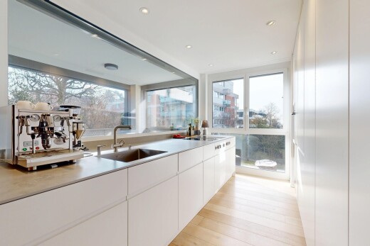 küche mit arbeitsplatten, weiße schränke, holzfußboden, wood finish floor, und natürliches licht