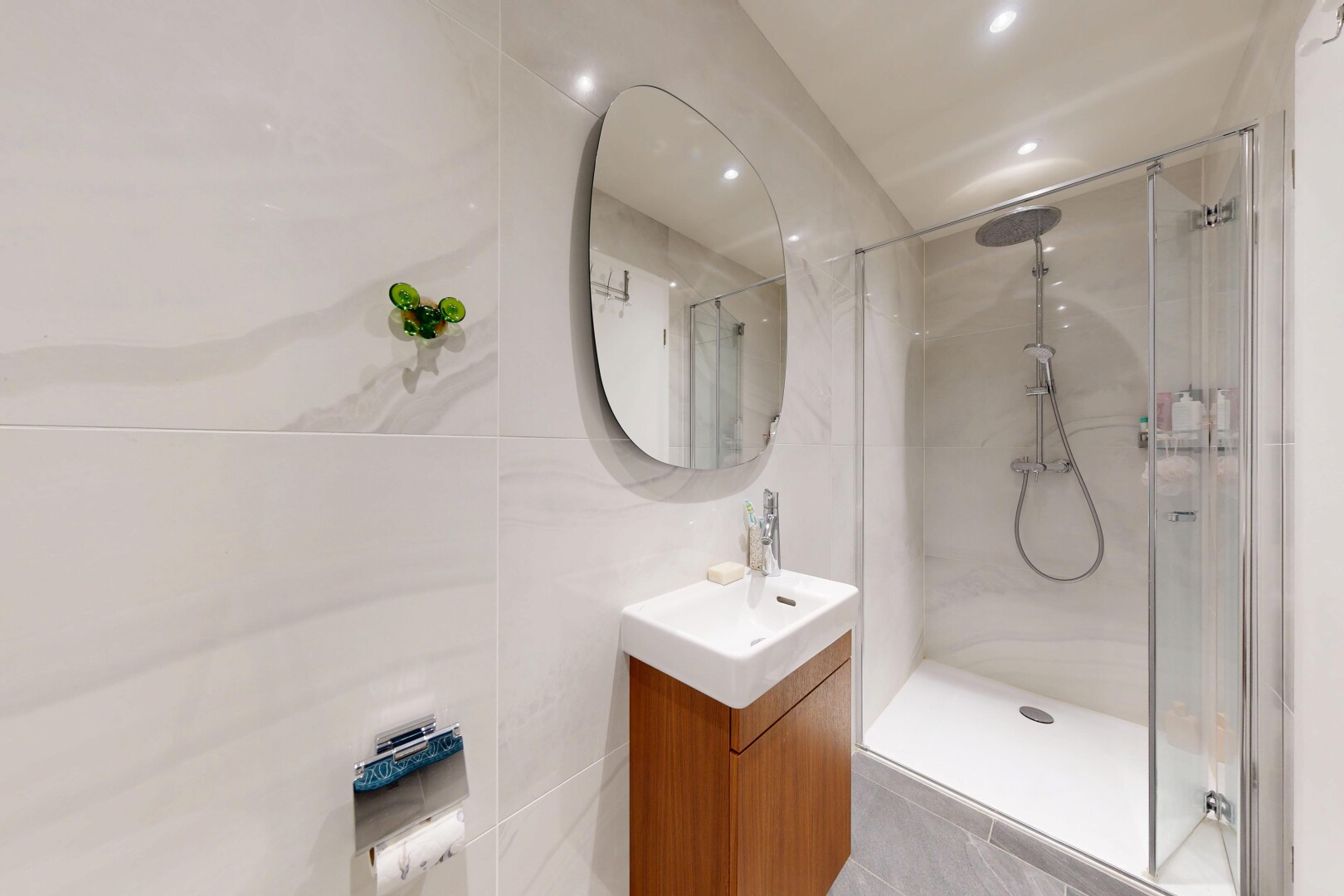 full bath featuring vanity, a shower stall, recessed lighting, and tile walls