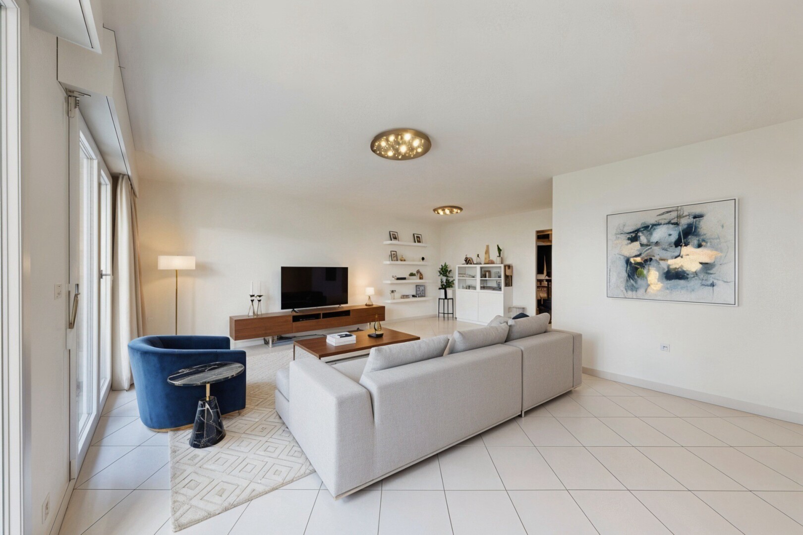 living area with light tile patterned floors and baseboards