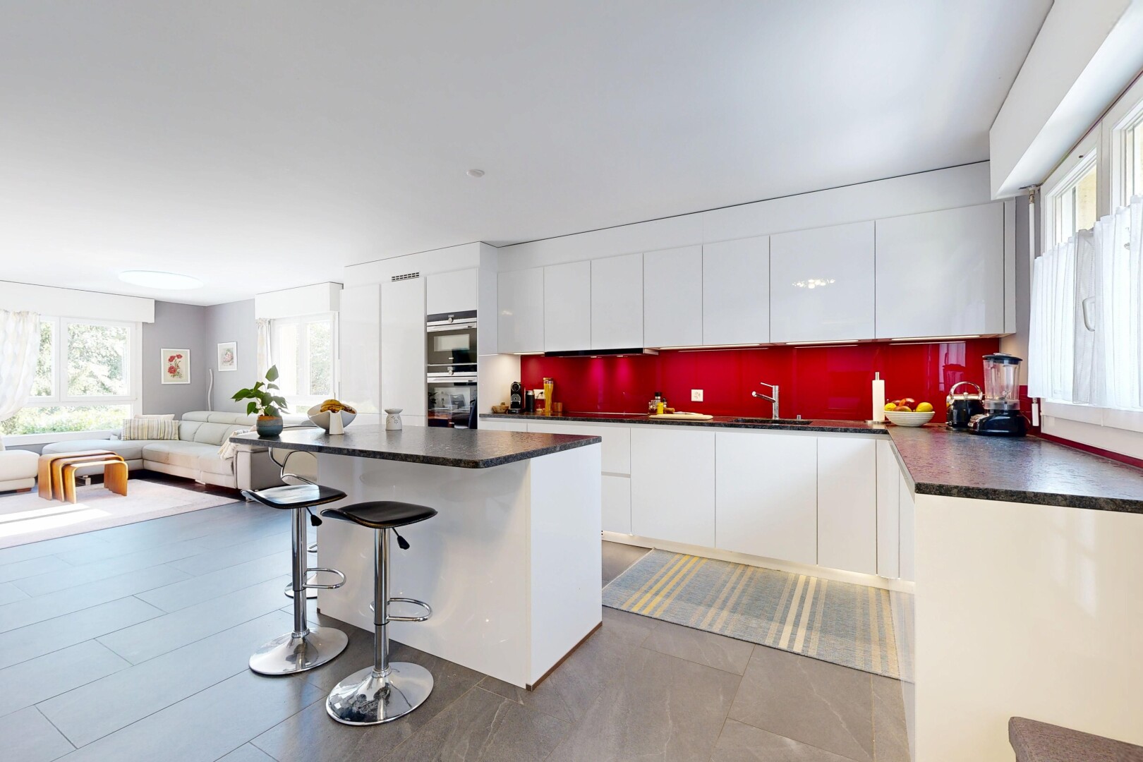 kitchen with healthy amount of natural light, dark countertops, and a breakfast bar area