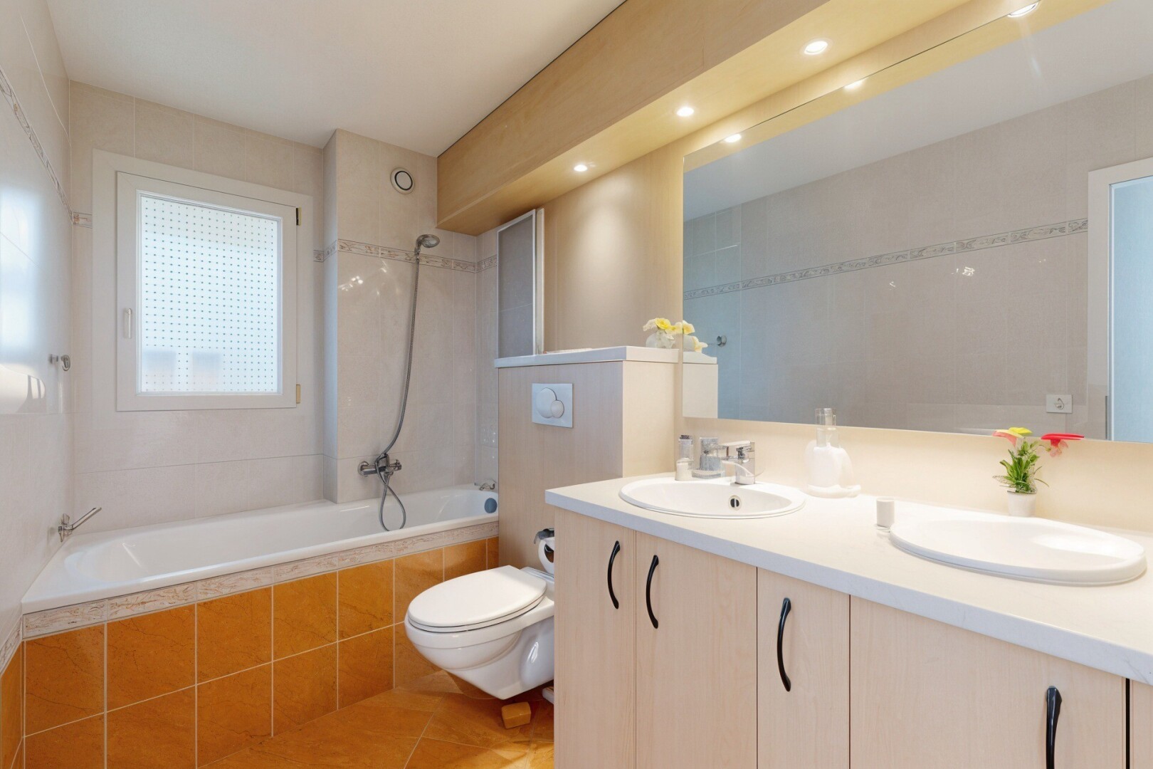 bathroom featuring tiled shower / bath combo, double vanity, light tile patterned floors, and recessed lighting