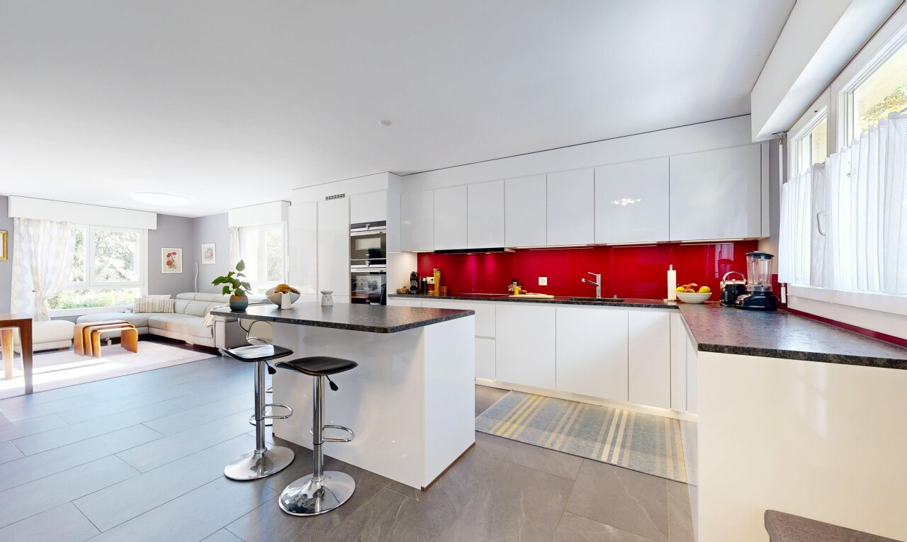 kitchen with healthy amount of natural light, dark countertops, and a breakfast bar area