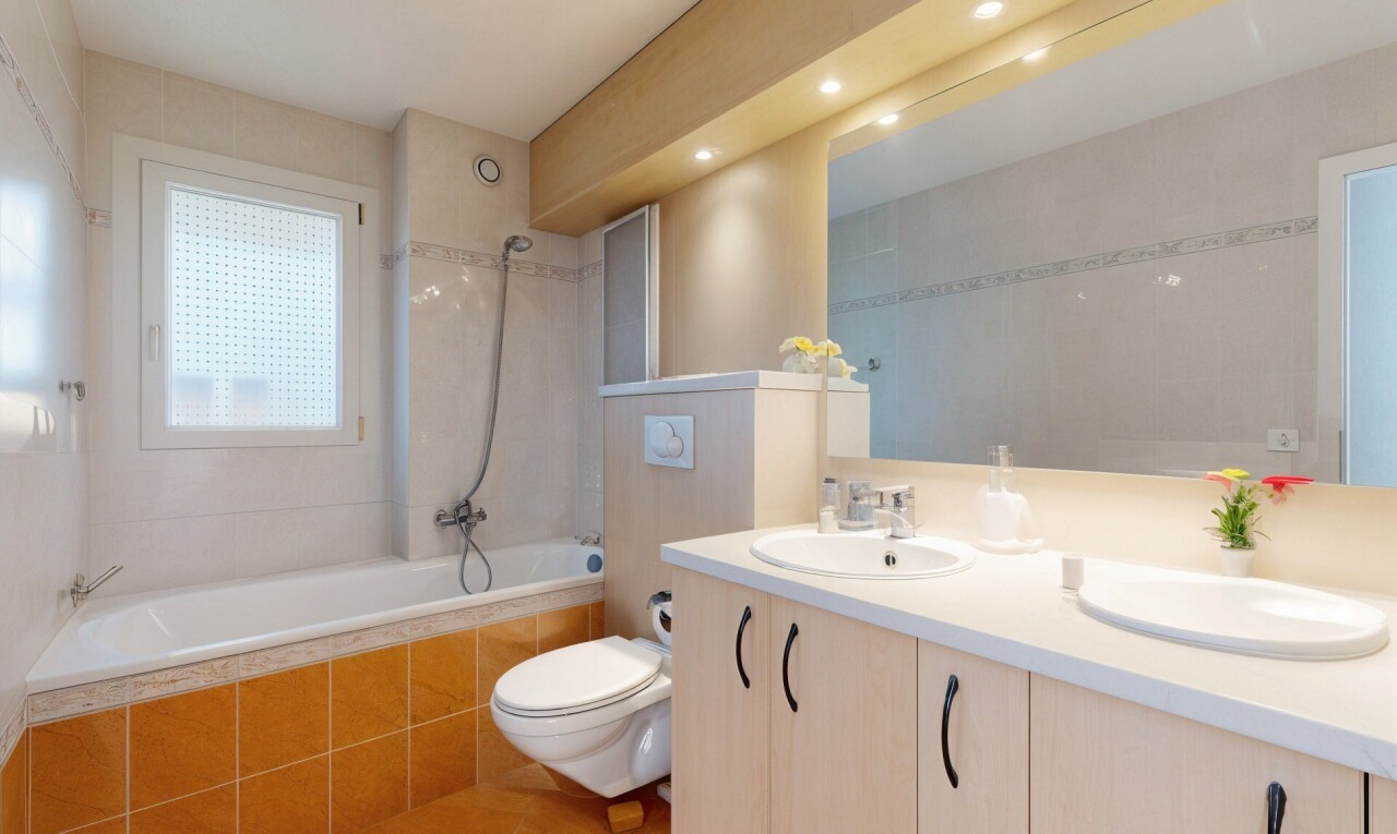 bathroom featuring tiled shower / bath combo, double vanity, light tile patterned floors, and recessed lighting
