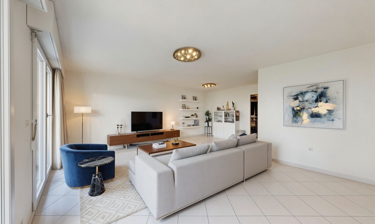 living area with light tile patterned floors and baseboards