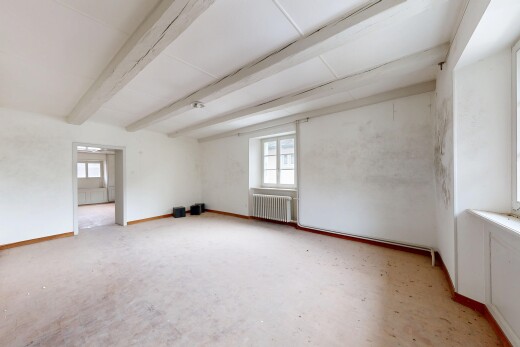pièce vide avec inside property, natural light, lumière naturelle, beamed ceiling, et plafond à poutres