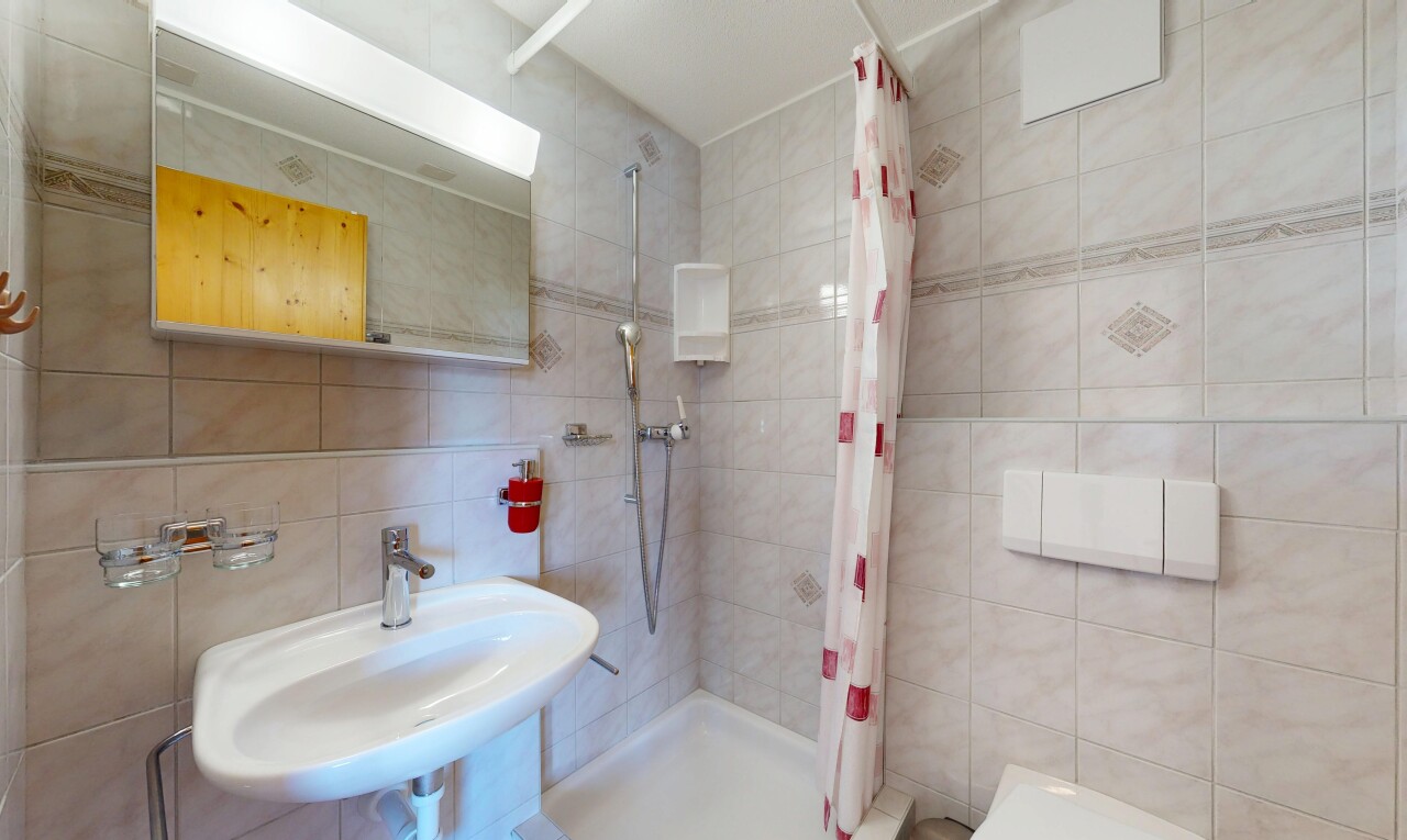 full bath with tile walls and a stall shower