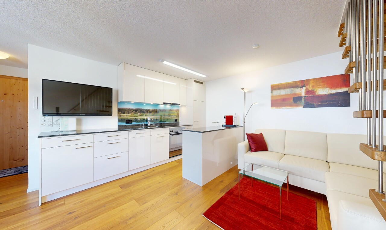 kitchen featuring dark countertops, light wood-style flooring, modern cabinets, open floor plan, and white cabinets