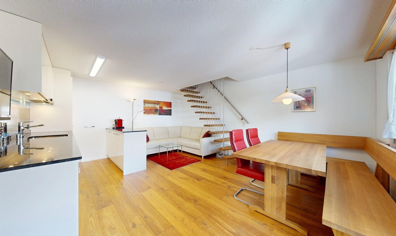 living / dining room featuring light wood finished floors, breakfast area, and a textured ceiling