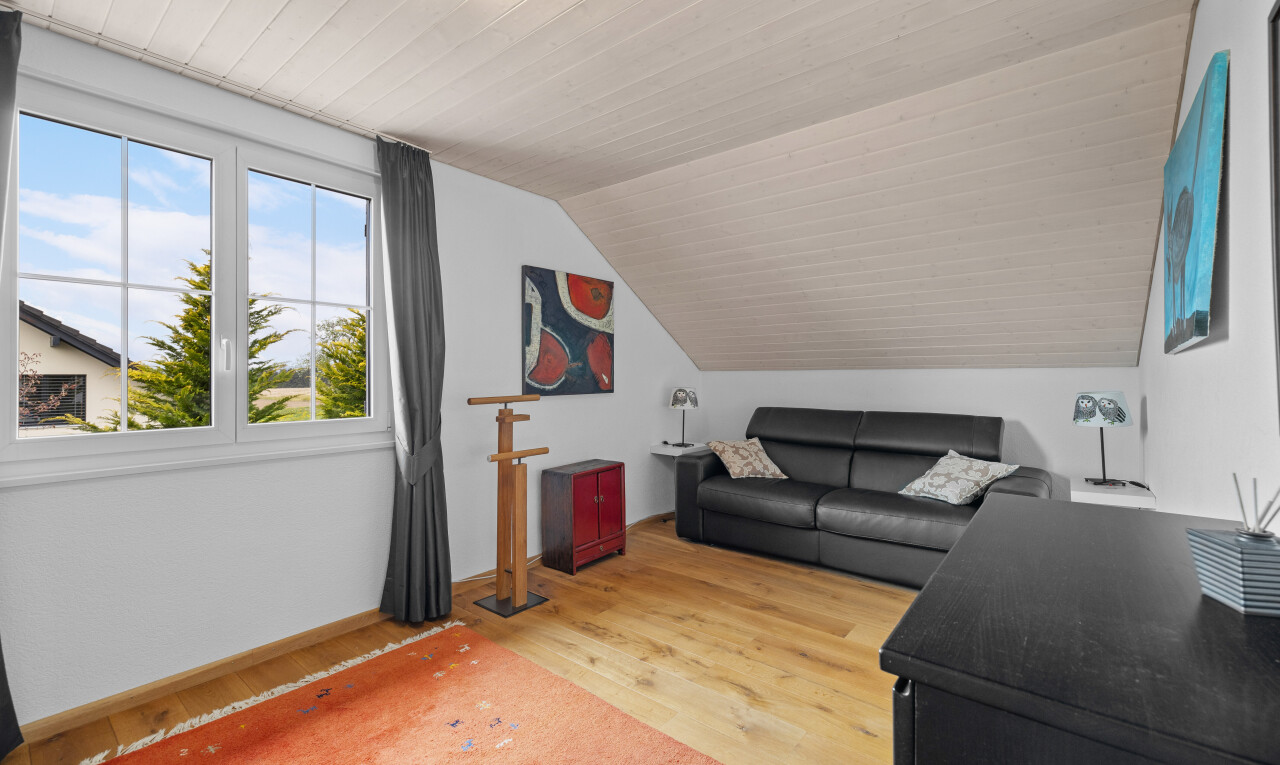 wohnzimmer mit natürliches licht, niedrige decke, zusätzliches zimmer, holzfußboden, und gipskartonwand