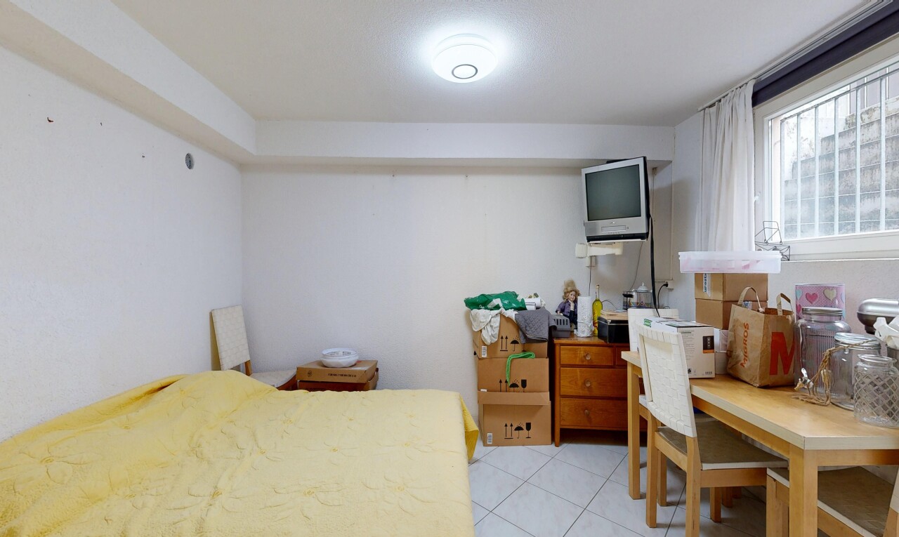 chambre avec inside property, cloison sèche, drywall, télévision, et light floor