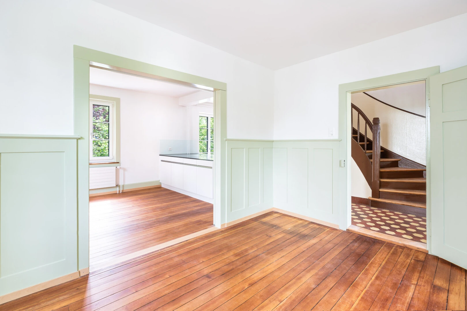 spare room featuring hardwood / wood-style flooring and wainscoting