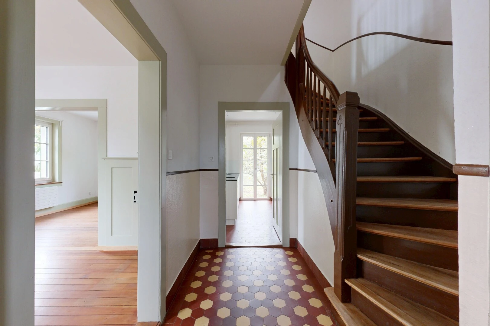 staircase with tile patterned floors and baseboards