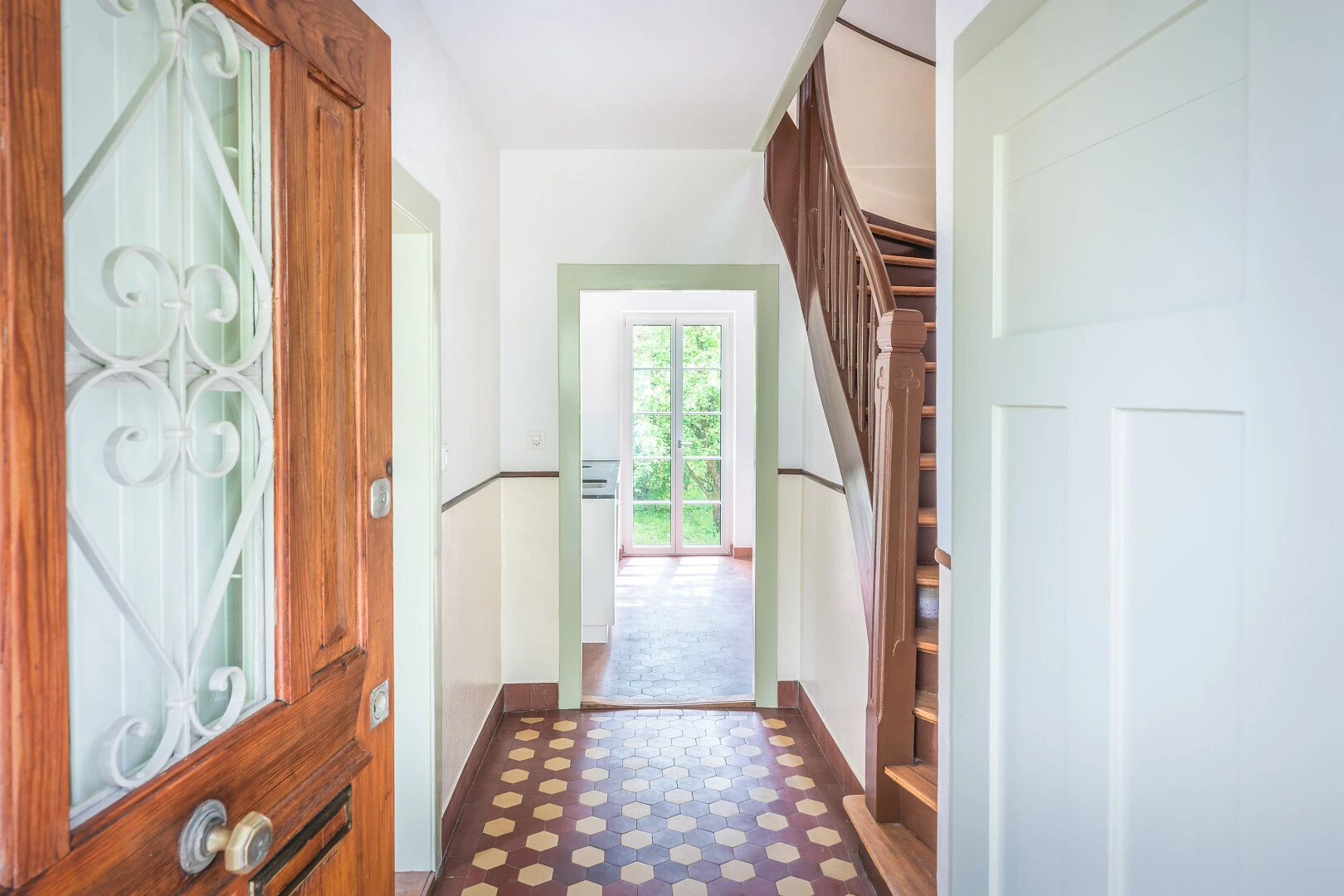 hall with dark floors and access to outside