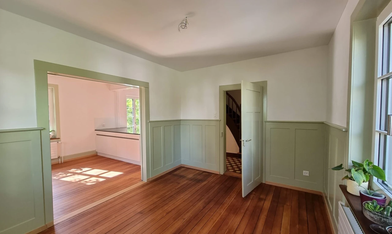 spare room featuring a wainscoted wall, a decorative wall, and hardwood / wood-style floors