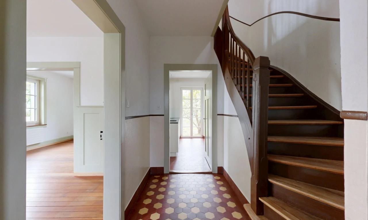 staircase with tile patterned floors and baseboards