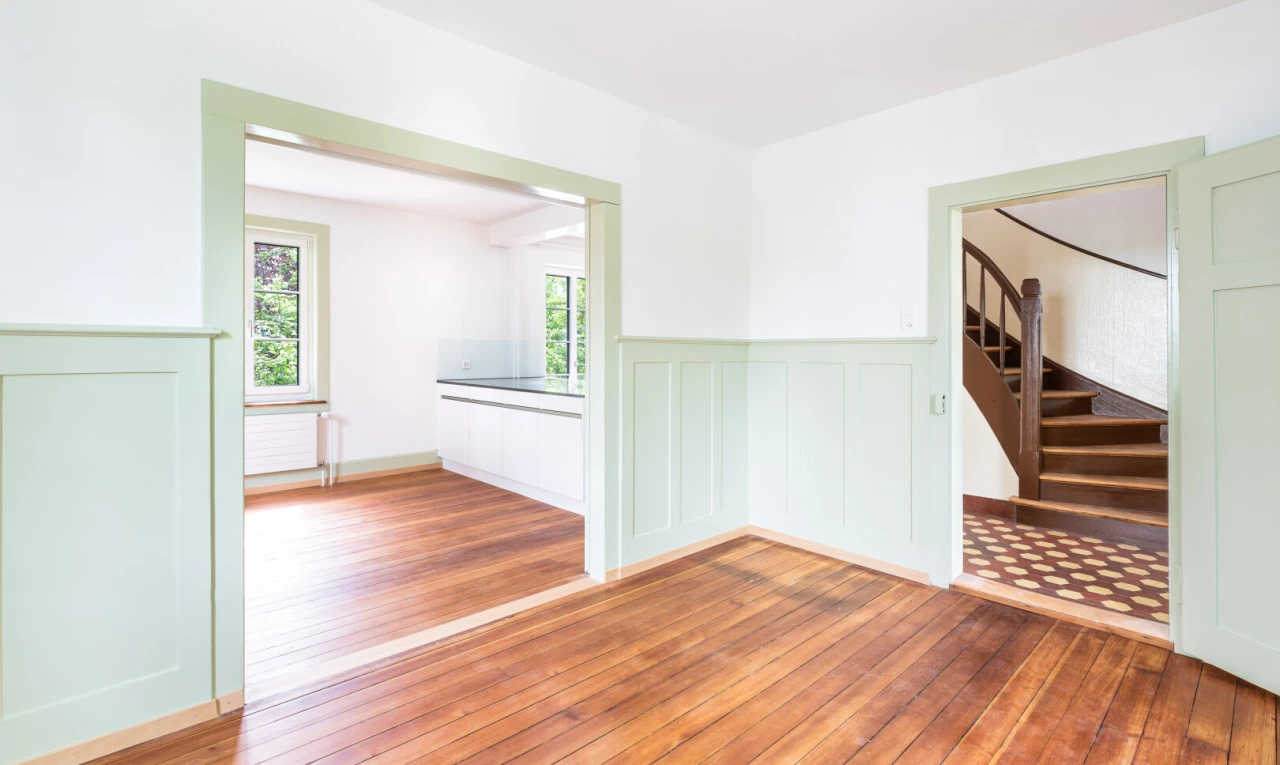 spare room featuring hardwood / wood-style flooring and wainscoting