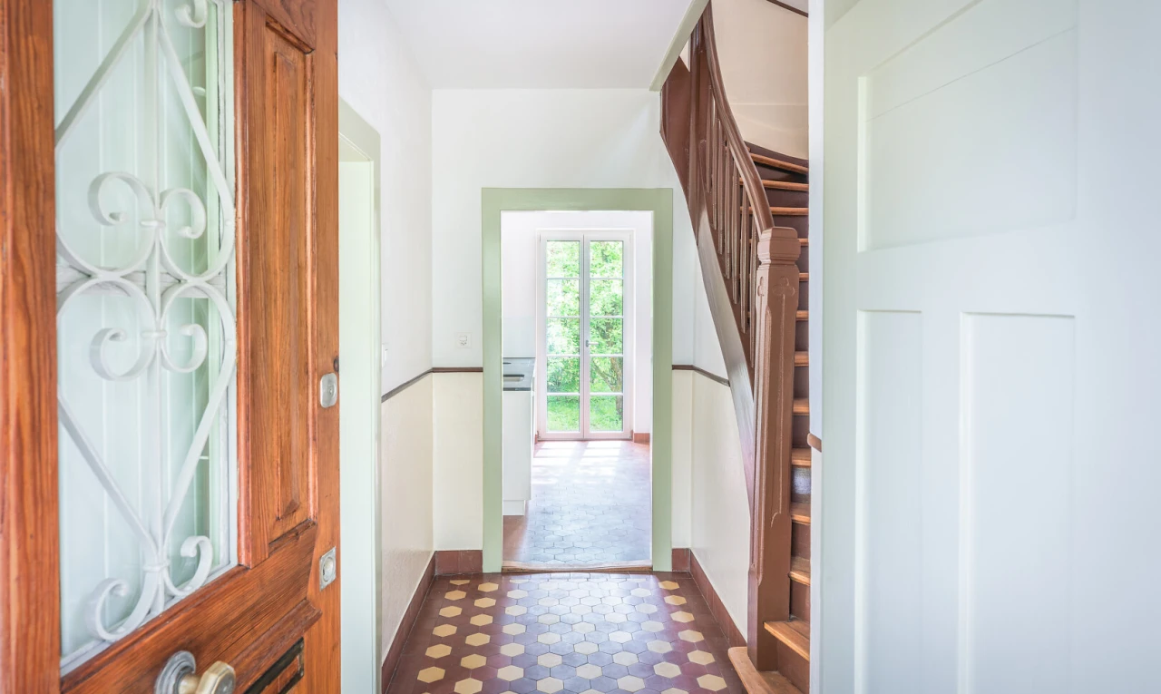 hall with dark floors and access to outside