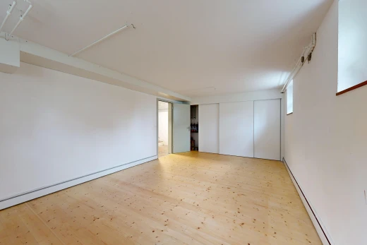 spare room featuring baseboard heating and light wood-style flooring
