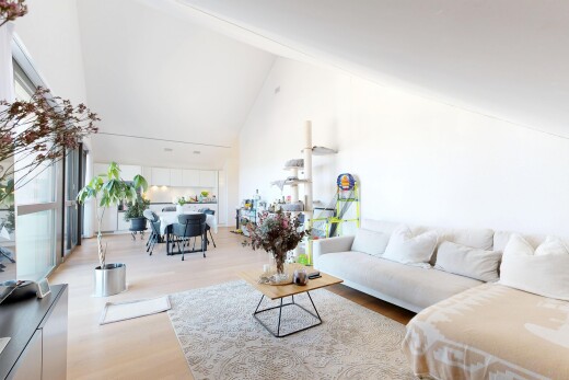 living area with wood finished floors and vaulted ceiling